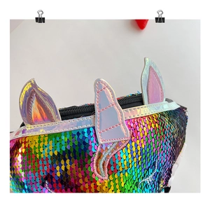 Macro shot of iridescent unicorn sequins and fine stitching on the girls crossbody bag