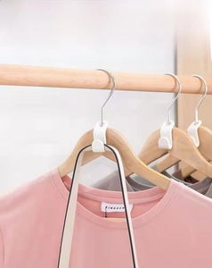 Close-up of minimalist white plastic hanger connector hook for vertical space-saving storage
