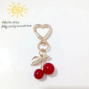Sweet cherry pendant keychain with red beads, gold leaves, and heart-shaped carabiner