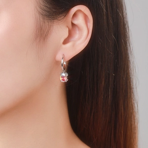Elegant S925 sterling silver hoop earrings with a faceted pink oval zircon on model