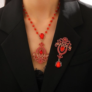 Vintage crystal pendant necklace set with red teardrop stones and gold metal filigree