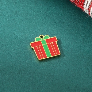 Detail of a red and green enamel gift box pendant in gold stainless steel for DIY jewelry