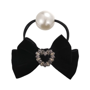 Elegant black velvet bow hair tie with a large pearl and sparkling heart rhinestone