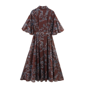 Back view of a floral chiffon maxi dress with lantern sleeves and waist tie in brown
