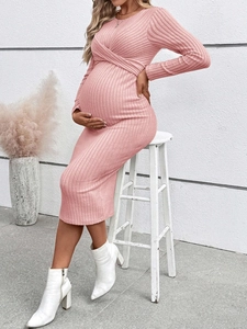Detail of pink long sleeve maternity dress showing knit ribbed texture on a model
