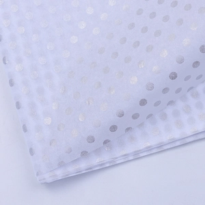 Close-up of semi-transparent white tissue paper with silver polka dots for bouquets