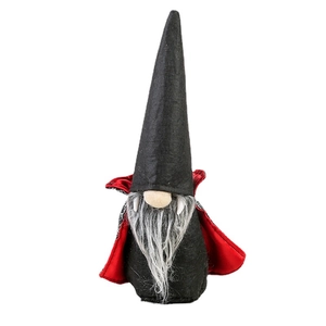 Halloween vampire gnome decoration with black cloak and red lining on white background