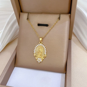 Close-up of gold Virgin Mary pendant with cubic zirconia inlay on a jewelry display box