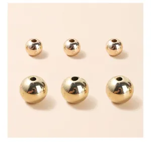 Detailed view of polished gold plated acrylic spacer beads in two sizes for DIY jewelry