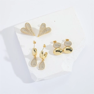 Three-piece gold earring set with heart and teardrop shapes featuring pavé zircon stones