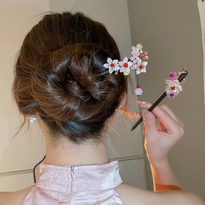 Detail of butterfly flower tassel hair sticks worn on an elegant bun hairstyle