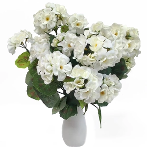 Detailed close-up of white artificial geranium flowers in a white ceramic vase