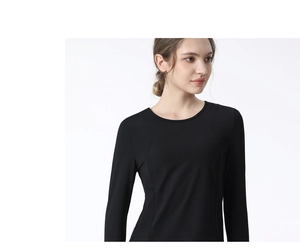 Detail of slim-fit black long sleeve sports top with crew neck and breathable fabric