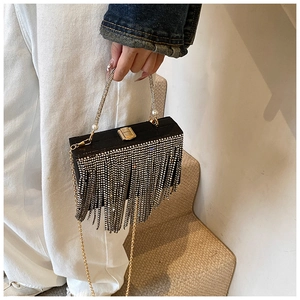 Detailed view of luxury black rhinestone tassel evening bag with elegant pearl handle strap