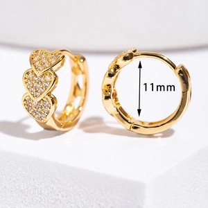 Close-up of heart-shaped gold earrings with micro-pave cubic zirconia and 11mm inner diameter