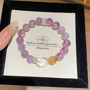 Detail of amethyst beaded bracelet with golden bead and silver spacers in gift box