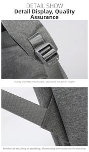 Detail showing adjustable shoulder strap buckle and reinforced stitching on gray diaper bag