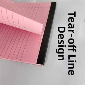 Close-up of the easy-tear perforated line design on a pink lined notepad page