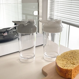 Set of two transparent portable plastic sports cups with ergonomic grips and leakproof lids