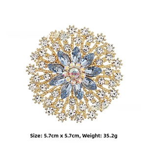 Detailed macro view of vintage sunburst brooch with blue marquise stones and gold plating