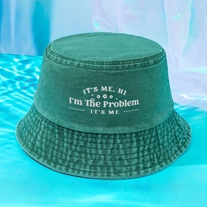 Dark green cotton bucket hat featuring white 'I'M THE PROBLEM' embroidery on blue background