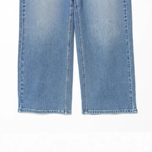 Close-up of high-waist wide-leg denim culottes showing hem stitching and fabric texture