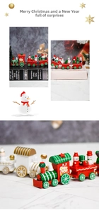 Detailed macro view of a red and green wooden Christmas train with mini Santa and snowman figures