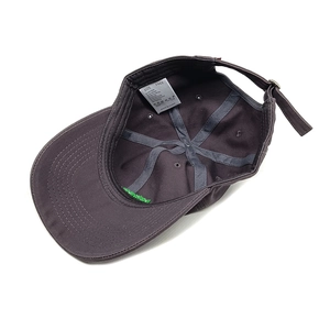 Detail view of cotton baseball cap interior with reinforced seams and adjustable metal buckle