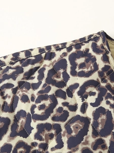 Detailed macro view of leopard print quilted fabric with high-quality diamond stitching