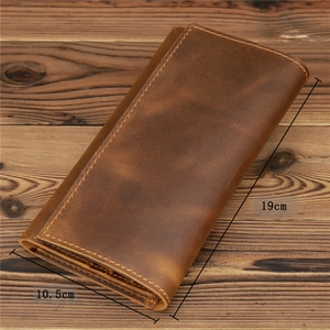 Macro shot of vintage brown leather long wallet showing dimensions 19cm by 10.5cm