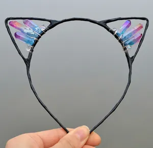 Close-up of handmade cat ear headband featuring gradient crystal stones and wire wrap