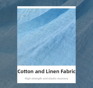 Close-up of light blue cotton linen fabric showing breathable texture and high elasticity