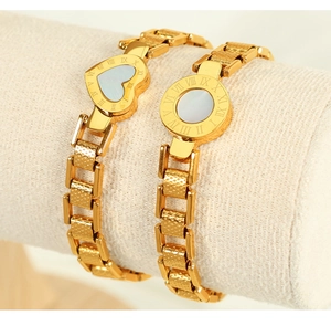 Detailed shot of gold plated steel bracelets with Roman numerals and mother of pearl