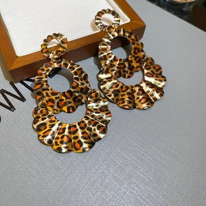 Close-up of leopard print layered circle earrings with vintage gold textured edges