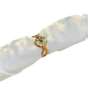 Vintage gold octagram star ring with a blue crystal on white silk background