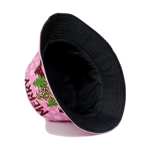 Pink Christmas bucket hat featuring festive tree prints and Merry text on cotton fabric