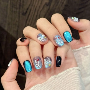 Blue cat eye press-on nails with wave patterns and starry sky hand-painted art