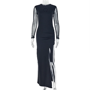 Detail of the high slit and ruched texture on this slim-fit black evening dress
