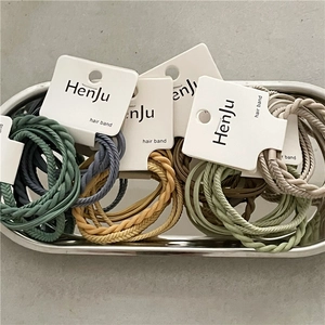 Detailed view of colorful elastic hair bands with spiral texture in a silver tray