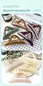 Detailed collection of assorted colorful triangle hair claws in matte and glossy finishes