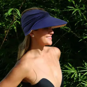 Side view of woman wearing a navy blue wide brim sun hat with pleated texture for outdoor sport