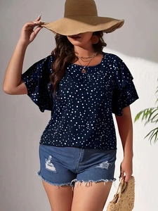 Detail of dark blue polka dot blouse with ruffle sleeves for casual summer beach vacation