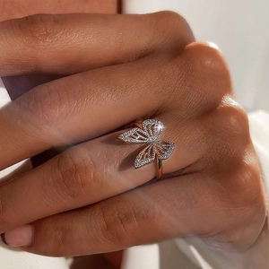 Elegant rose gold butterfly ring with micro-pave cubic zirconia on a model's hand