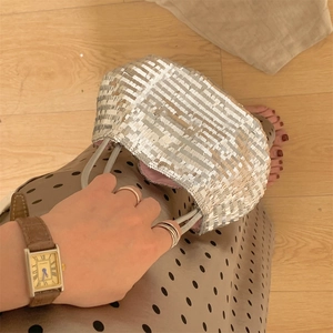 Detail of silver sequin tote bag showing glittering texture and stylish metallic finish