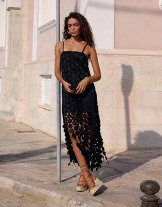 Detail of French hollow dot midi dress with spaghetti straps and tassel hem in black
