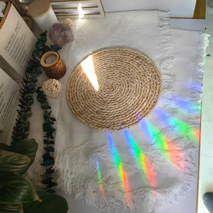Rainbow light refraction on a round natural straw placemat in a cozy home setting