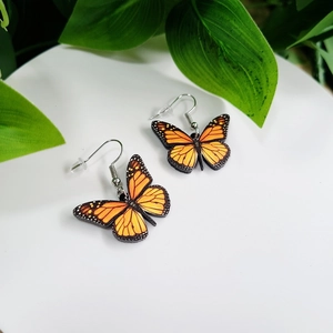 Elegant orange butterfly wing drop earrings with silver hooks for women on white base