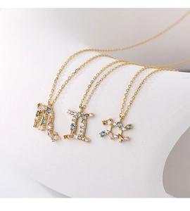 Detailed view of rainbow zircon zodiac pendants on dainty gold chains for women