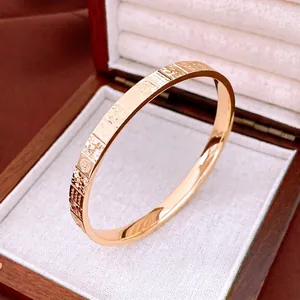 Rose gold minimalist cuff bracelet with textured geometric patterns in a luxury gift box