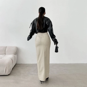Back view of a high-waisted split leather maxi skirt paired with a black biker jacket
